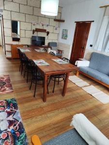 a living room with a wooden table and chairs at Ruta del Agua in Cuevas del Palmar