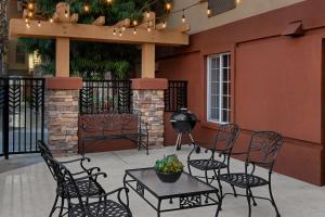 a patio with chairs and a table and a building at Larkspur Landing Extended Stay Suites Pleasanton in Pleasanton +21 photos