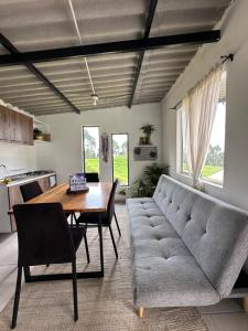 a living room with a couch and a table at Cabaña privada cerca a termales San Vicente in Santa Rosa de Cabal