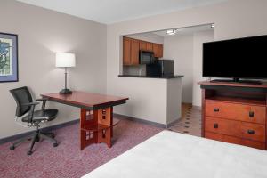 a hotel room with a desk and a tv and a desk and chair at Larkspur Landing Extended Stay Suites Renton in Renton