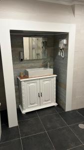 a bathroom with a white sink and a mirror at Casa da Ti Cristina in Pomares +45 photos