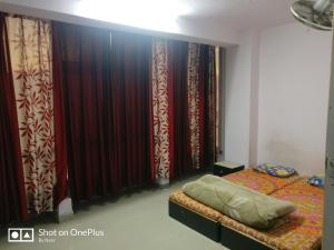 a bedroom with curtains and a bed in a room at Hotel Maya Residency in Jaipur