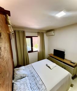 En eller flere senge i et værelse på Apto Sossego - Barbosa acomodações