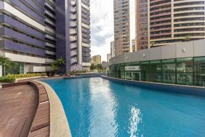 a swimming pool in a city with tall buildings at Beach Class Queridinho Apto 2Qtos 50m Praia in Fortaleza