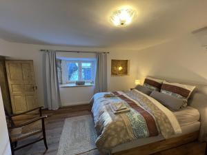 a bedroom with a large bed and a window at Am Hirtenturm, anno 1397, auf der Quelle der Ahr in Blankenheim