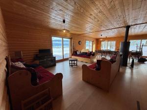 a living room with couches and a fireplace in a log cabin at Maison lumineuse 3 chambres à Méaudre - 8 pers, près des pistes - FR-1-737-3 in Méaudre