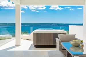 a living room with a view of the ocean at MY DALMATIA - Luxury villa Michelle with private infinity pool, sea view jacuzzi, sauna and home gym in Maslenica