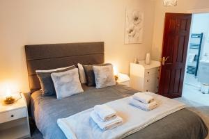 a bedroom with a large bed with towels on it at Bellman's Hideaway in Bowness-on-Windermere