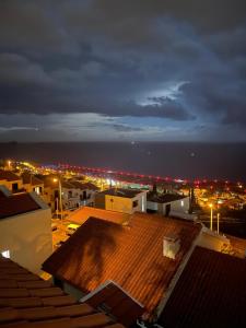a view of a city at night with lights at Marilu!! in Madeira Cristiano Ronaldo Airport +4 photos