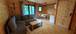 a living room with a couch and a table at Toscana Camp in Pogorzelica