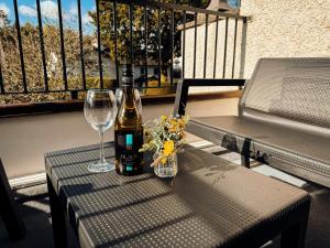 a bottle of wine and a glass on a table at Bellman's Hideaway in Bowness-on-Windermere