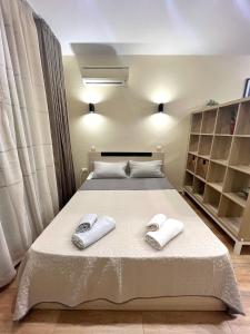 a bedroom with a bed with towels on it at Salt Lake Studio in Pomorie