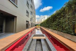 a empty hallway of a building with a bench at SureStay by Best Western Iconic Ari-Jatujak in Bangkok
