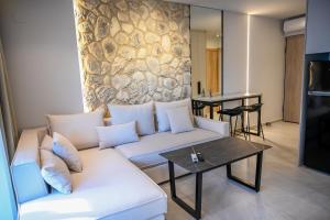 a living room with a couch and a table at Aqua Lora in Nikiana