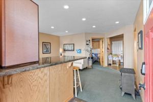 a kitchen with a bar and a living room at Cozy 2.4 in Hayden +26 photos