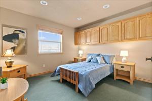 a bedroom with a bed and a table and a window at Cozy 2.4 in Hayden