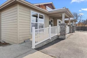a small house with a white fence in front of it at Cozy 2.4 in Hayden