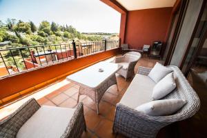 a balcony with a couch and chairs and a table at Villa Lavanda in San Miguel de Allende