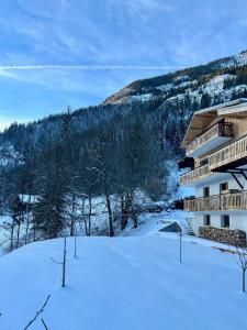 a building in the snow with a snow covered yard at Chalet Flachaire in Abondance