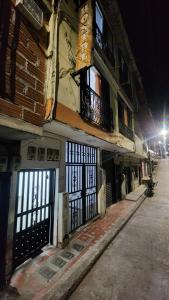 an old building with doors and windows at night at Hostal SHELTER LA PERLA - San luis, Antioquia, Colombia in San Luis +4 photos