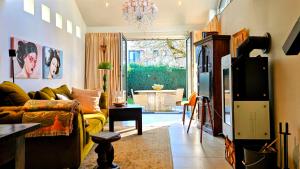a living room with a couch and a tv at Taunusgarten in Bad Camberg