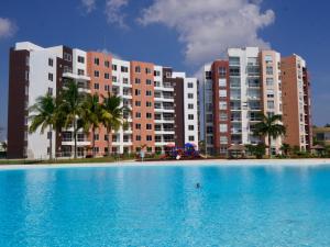 a large swimming pool in front of tall buildings at Dreams Lagoon in Cancún +11 photos