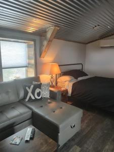 a living room with a couch and a bed at Boulderdash Birdhouse Studio in Bandera
