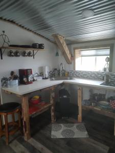 a kitchen with a counter top and a sink at Boulderdash Birdhouse Studio in Bandera +21 photos