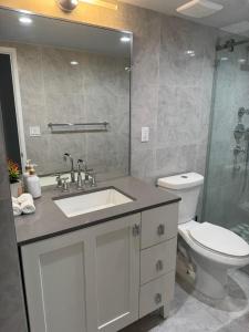 a bathroom with a sink and a toilet at Spacious Apt Ocean Reserve Resort Amenities in Sunny Isles Beach