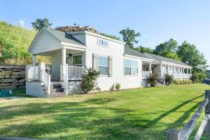 a small white house with a yard at CrossTimbers Marina and Cottages in Sperry