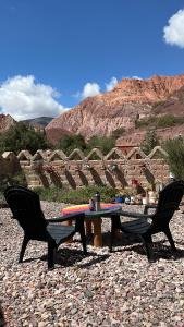 a table and two chairs sitting next to a table at Hosteria La Pushka in Purmamarca