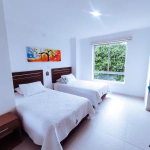 Rúm í herbergi á Hotel Suma Wasi