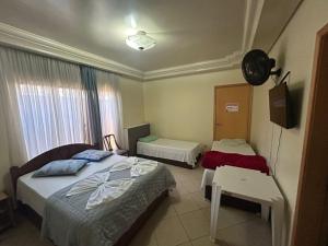 Postel nebo postele na pokoji v ubytování POUSADA DO NIVINHO