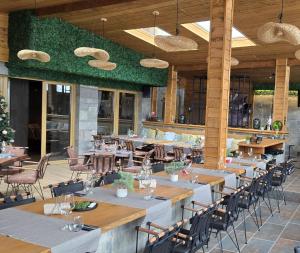 a restaurant with wooden tables and chairs and tablesearcher at BOUTIQUE Hotel ENTRY E in Bansko +50 photos