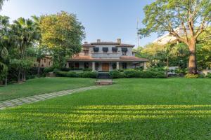 a large house with a lawn in front of it at Casa Corbellani in Asunción