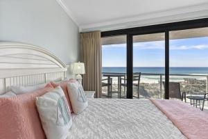 a bedroom with a bed with a view of the ocean at Beachside II #4247 in Destin +27 photos
