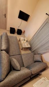 a living room with a couch and a table at Nylio Apartment in Preveza