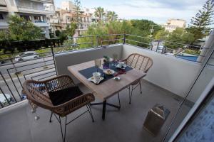 a balcony with a table and chairs on a balcony at Liberty Suites II in Heraklio