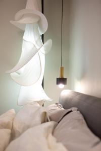 a white lamp sitting next to a couch at Liberty Suites II in Heraklio