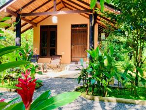 a front porch of a house with a wooden door at suncity privacy cottages in Udawalawe