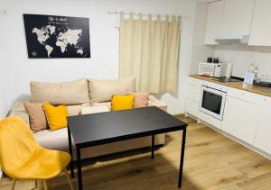 a living room with a couch and a table at Libertad A in Santiponce +19 photos