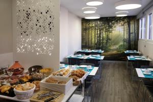 a room filled with tables with bread and pastries at Salamanca Suite Studios in Salamanca