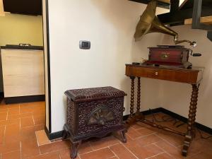 a room with a table and a wood stove at Rosari Spada Suite sec XVI in Spoleto