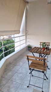 a patio with a bench and a table at Nylio Apartment in Preveza