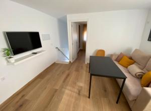 a living room with a couch and a flat screen tv at Libertad A in Santiponce