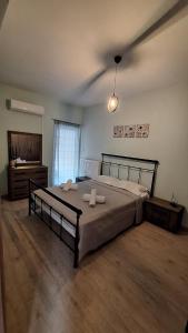 a bedroom with a large bed with two pillows on it at Nylio Apartment in Preveza