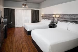 Postel nebo postele na pokoji v ubytování Samuels Boutique Hotel