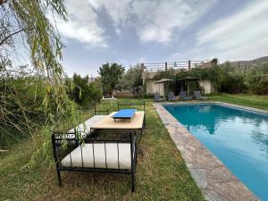 a picnic table next to a swimming pool at Ferme Tibrijine in Marrakesh