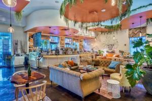 a large living room with couches and a bar at Sunrise Surprise 9th floor 2BR 2 BA King Suite Beach shuttle, heated pool! in Destin