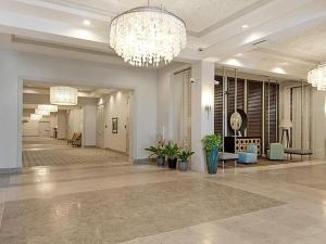 a large lobby with a chandelier in a building at Sunrise Surprise 9th floor 2BR 2 BA King Suite Beach shuttle, heated pool! in Destin